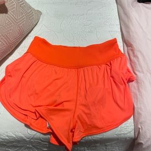 Free people movement shorts size large. Neon orange